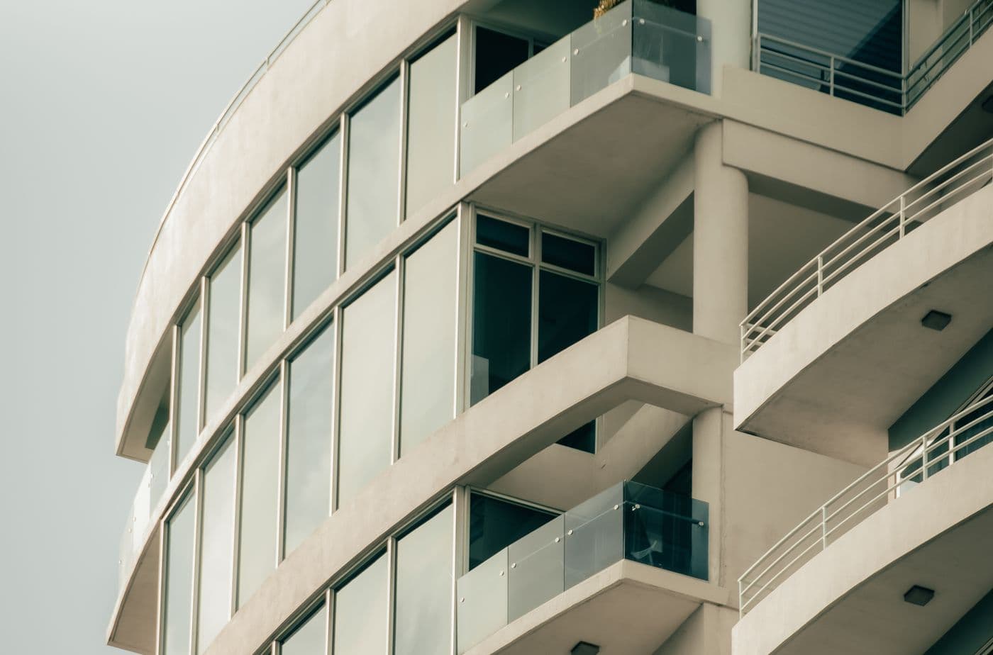 Curved white residential building in the Althan area of Surat