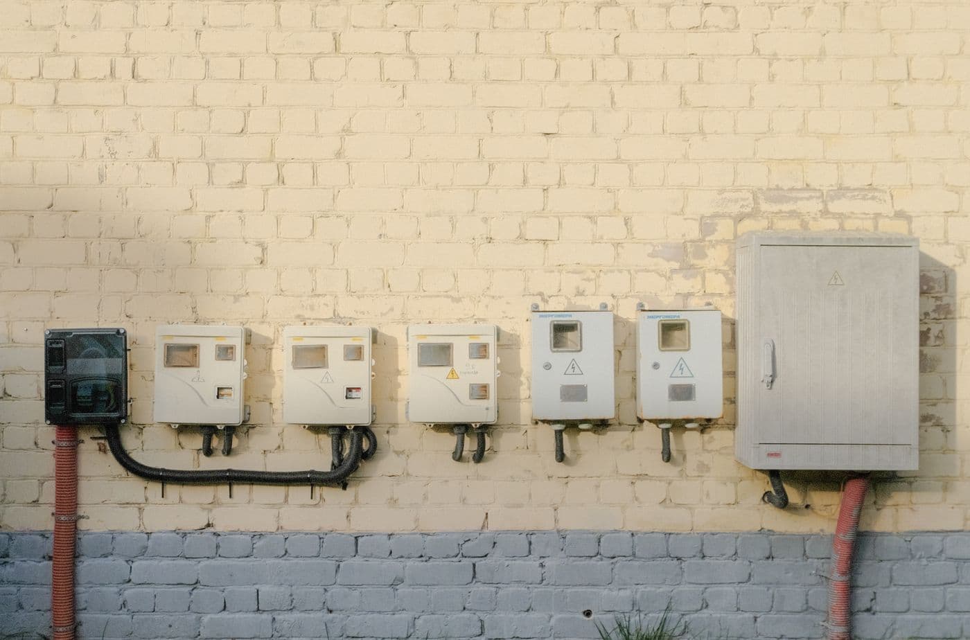 Bank of electricity meters mounted on a building wall