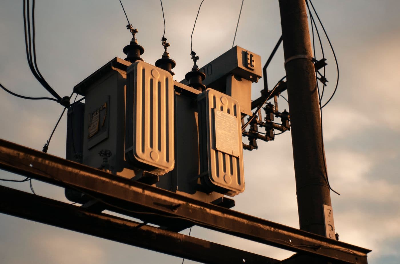 Electrical distribution equipment and transformers against an evening sky