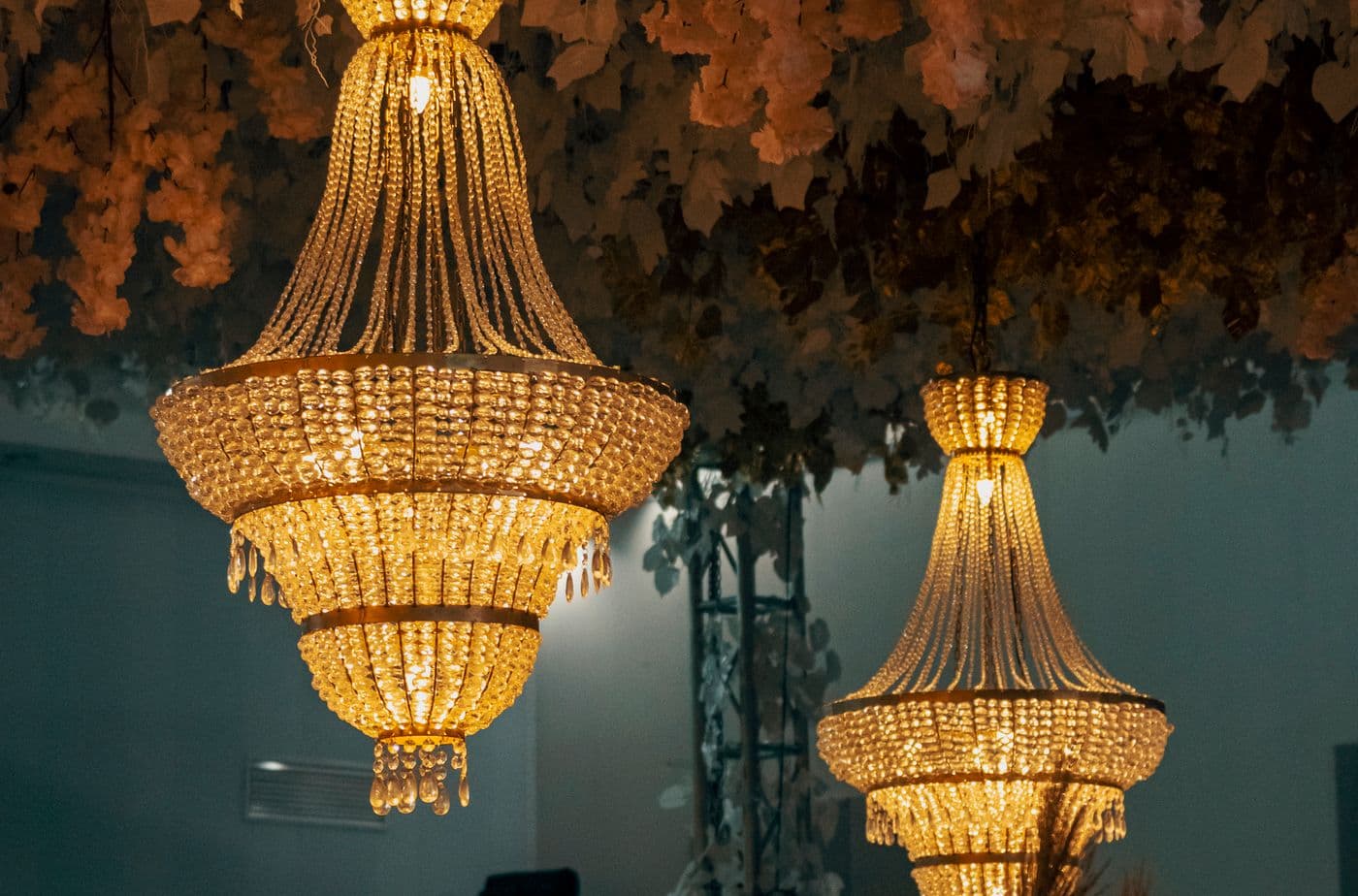 Ornate chandelier hanging in a warmly lit interior space