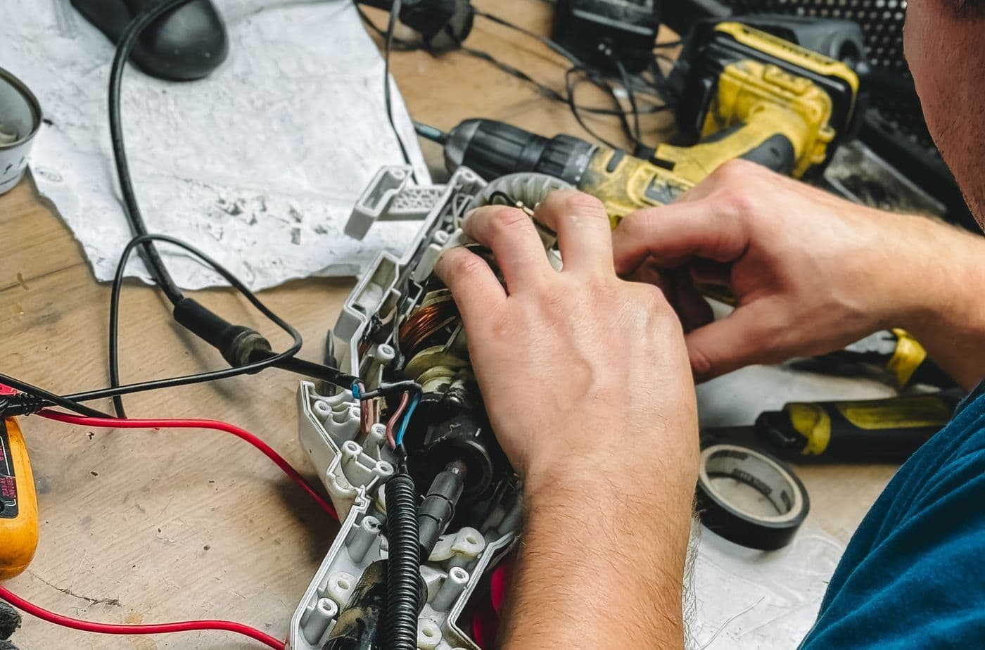 Electrician stripping and terminating copper cable during a house rewiring job