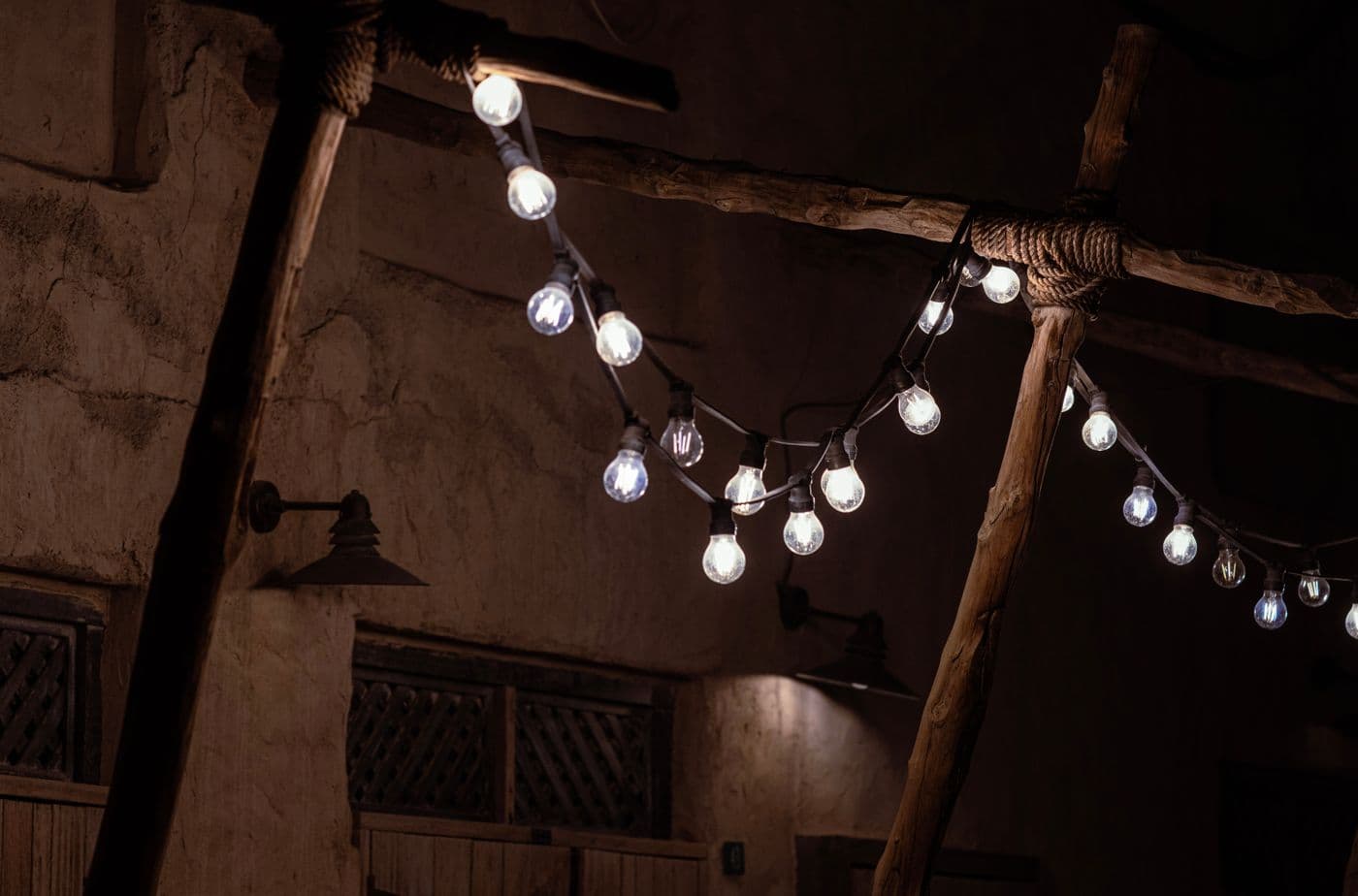 String lights and outdoor fittings illuminating a terrace at dusk