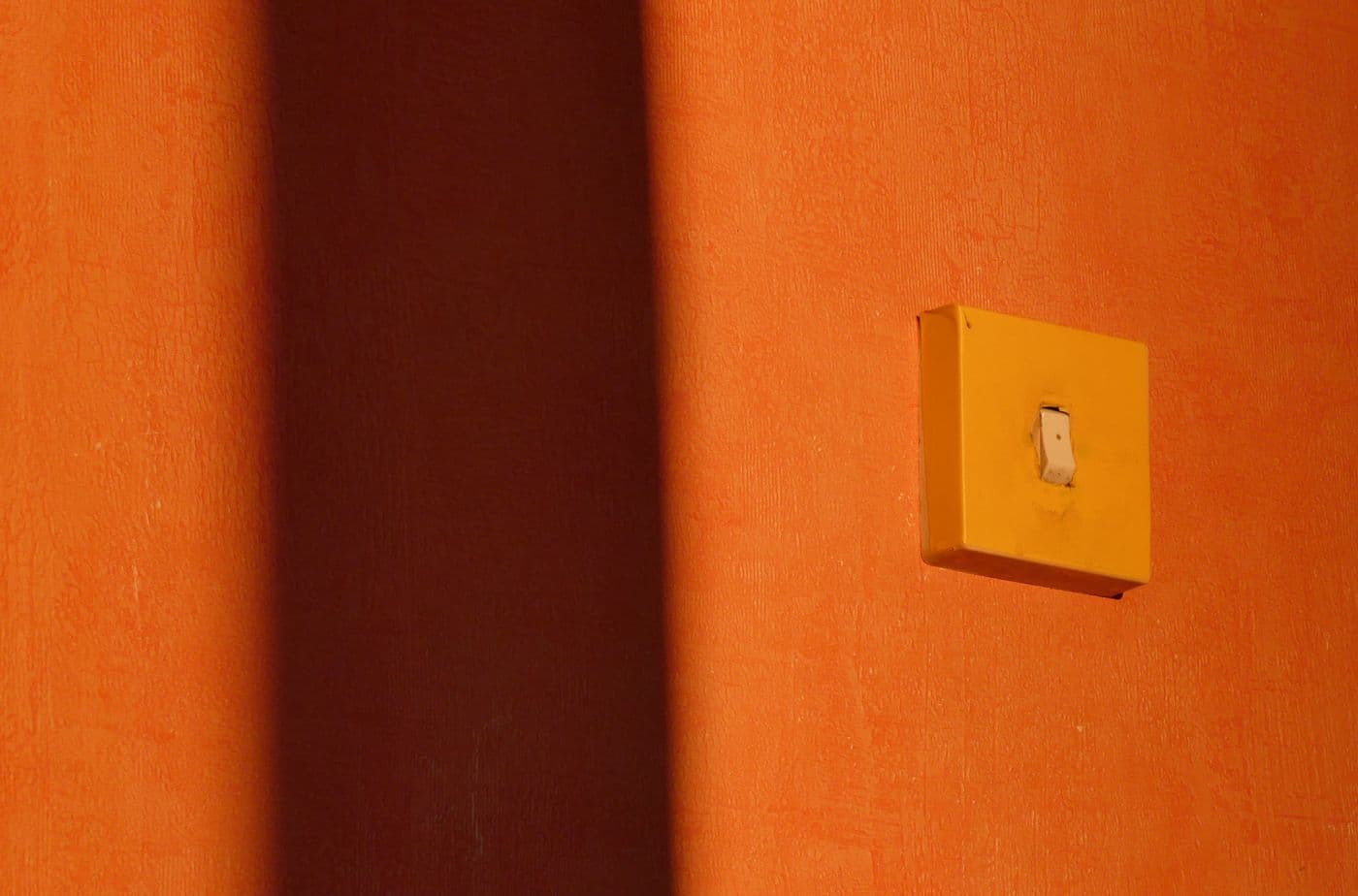 Modern socket outlet fitted neatly on a warm painted interior wall